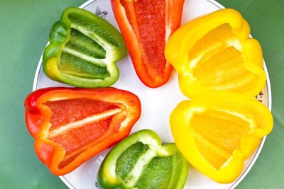 Cut in halves clourful peppers slices on a plate jigsaw puzzle