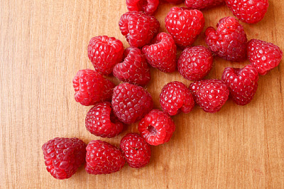 Composition of many raspberries on bright wooden t jigsaw puzzle