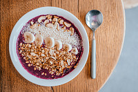 Beautiful blueberry banana smoothie bowl with a sp