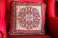 Red pattern pillow on red chair