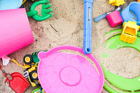 Colorful toys in the sandbox. Happy childhood, way