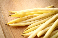 Yellow beans (French beans) on rustic wooden table