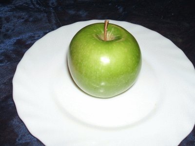 Green apple on a plate